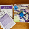 Image of the birth control education kit open displaying patient education materials and demo birth control products with tags.