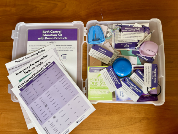 Image of the birth control education kit open displaying patient education materials and demo birth control products with tags.